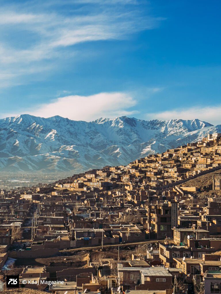 Terraced mud homes beneath snow-capped mountains