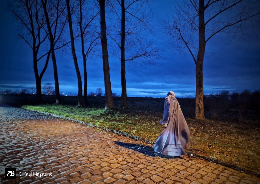 Woman in white Burqa walking at twilight