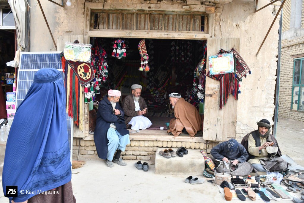 Woman in Burqa passing across a shop