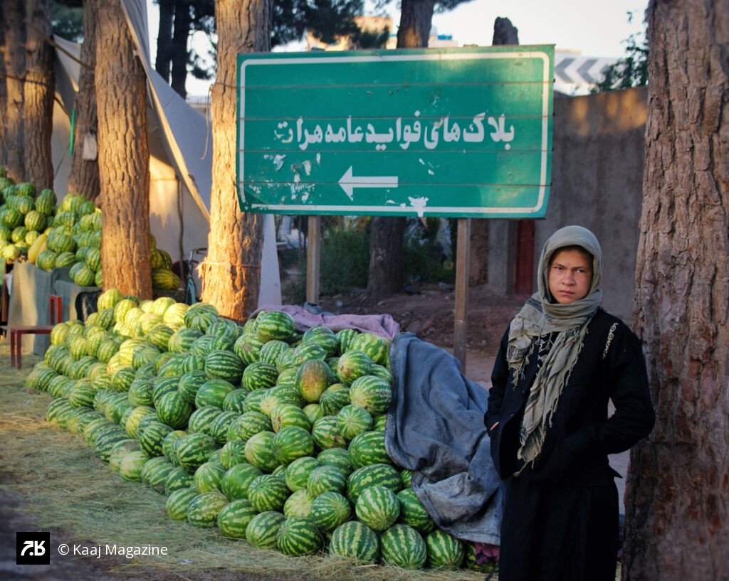 Boy selling watermelons by the road