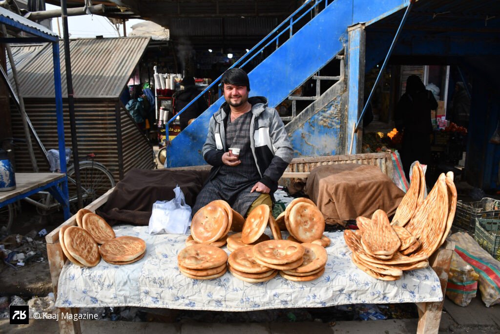Bread vendor smiling at his stall