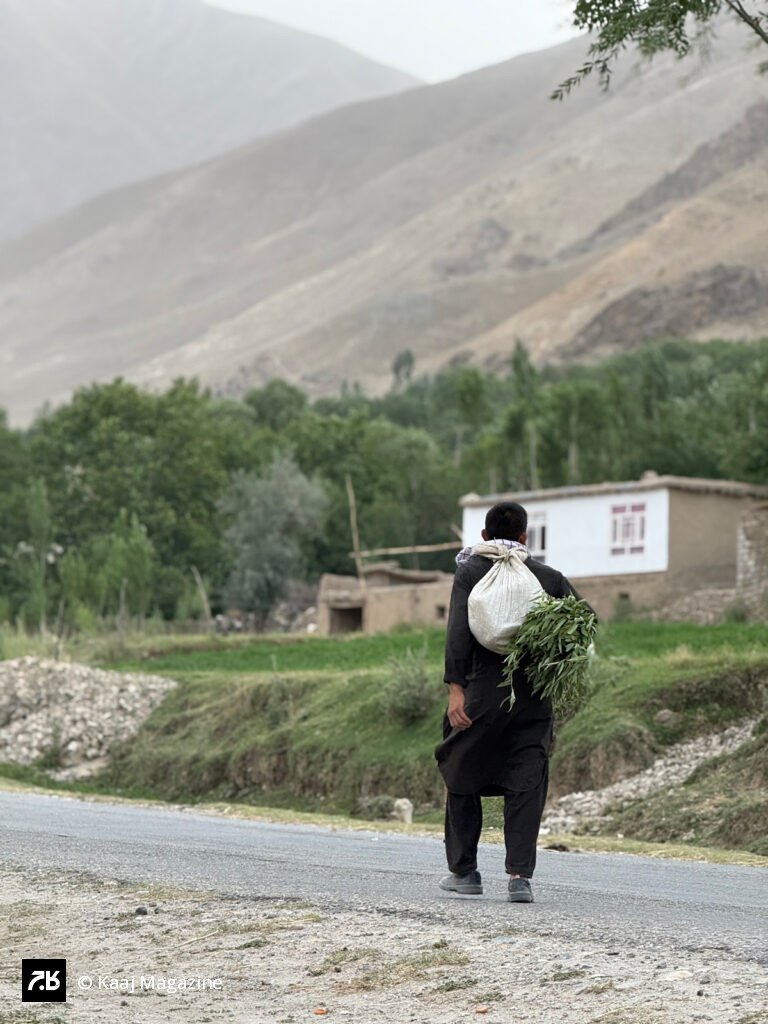 Man carrying a heavy white sack