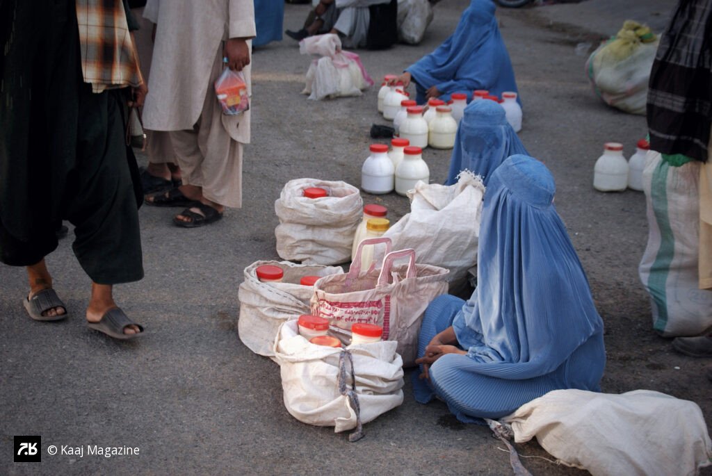 Women in burqas selling dairy goods
