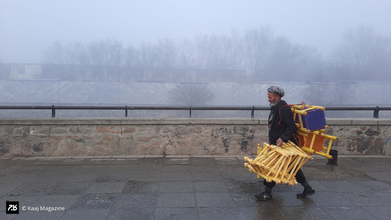 Man carrying stools in thick fog